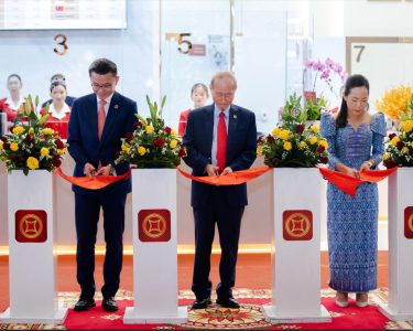 Ribbon Cutting Ceremony, presided over by Lok Neak Okhna Dr. Pung Kheav Se, Chairman of Canadia Bank (center), alongside Mr. Raymond Sia, CEO (left), and Ms. Song Khenglay, COO (right).