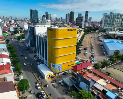 Striking new Maybank Olympic Branch by FUTURE Architecture, featuring a bold yellow façade and immersive interior design beside Phnom Penh’s National Olympic Stadium.