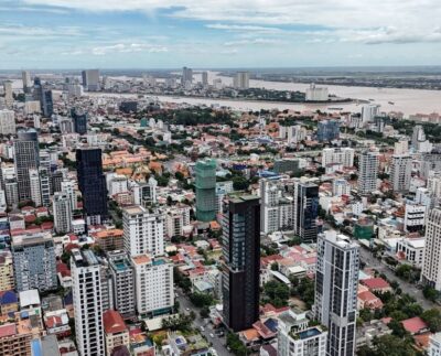 An aerial view shows the city skyline with high-rise buildings in Phnom Penh on July 19, 2025.