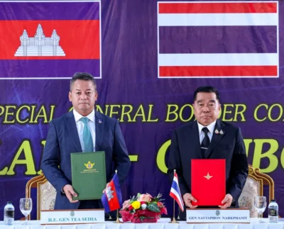 Cambodia's Defense Minister Tea Seiha, left, and Thailand's Defense Minister Nattaphon Narkphanit hold documents during the special General Border Committee meeting at a border checkpoint in Thailand's Chanthaburi province.Agence Kampuchea Press / AFP Photo